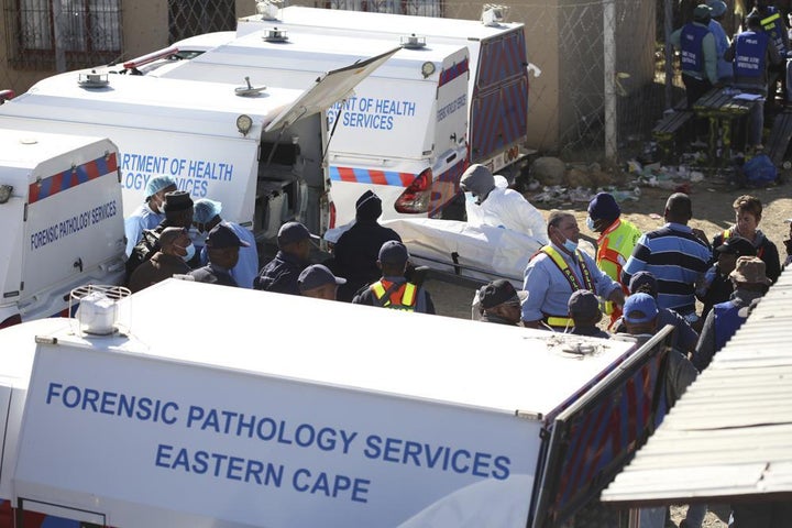 A body is removed from a nightclub where 21 teenagers died in the early hours of the morning, in East London, South Africa on June 26.