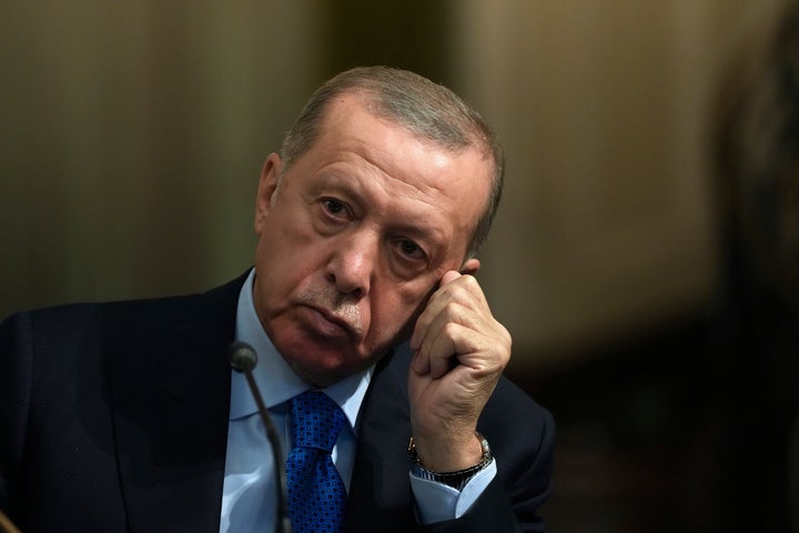 Turkish President Recep Tayyip Erdogan scratches his face as he listens to his Iranian counterpart Ebrahim Raisi during their joint press briefing at the Saadabad palace, in Tehran, Iran on July 19, 2022.