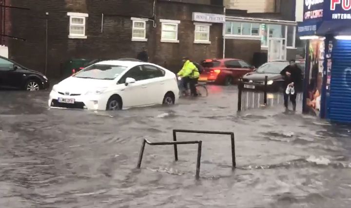 Handout hoto taken with permission from the twitter account of @braggendasz showing a flooded road in Turnpike Lane, north London, after heavy rainfall, on July 12, 2021.