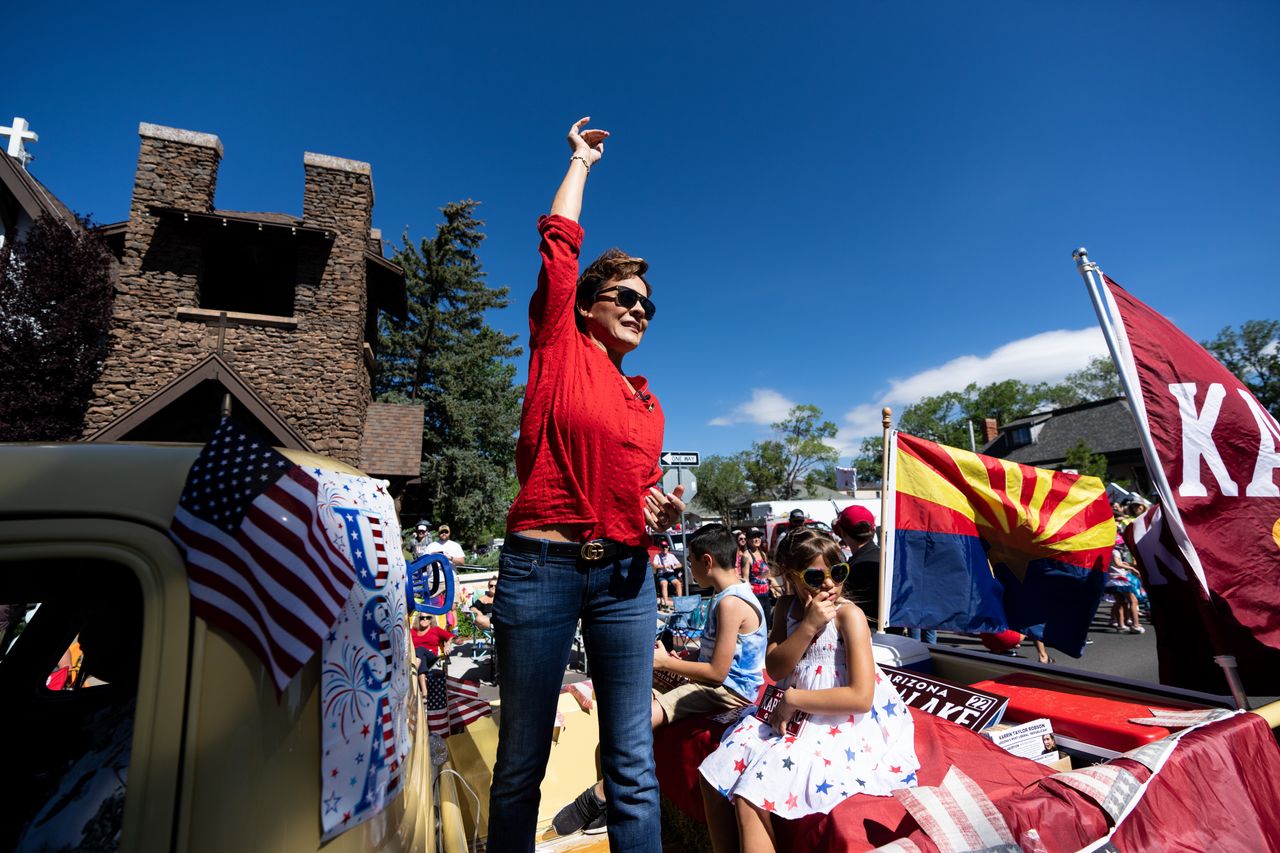 Kari Lake, Republican candidate for Arizona governor, campaigned at a July Fourth parade in Flagstaff. Lake has a packed campaign schedule ahead of the state's Aug. 2 primary.
