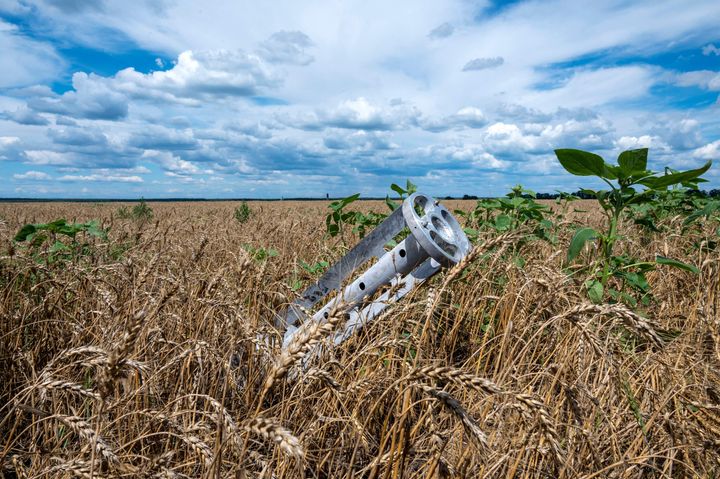 A fragment of a rocket from a multiple rocket launcher is seen embedded in the ground on a wheat field in the Ukrainian Kharkiv region on July 19, 2022, amid Russian invasion of Ukraine. (Photo by SERGEY BOBOK / AFP) (Photo by SERGEY BOBOK/AFP via Getty Images)