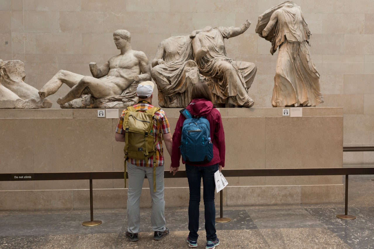 Visitors admire the sculpture of the ancient Greek Parthenon's Elgin Marbles Metopes in the British Museum.