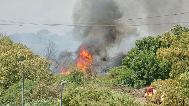 Firefighters attend a fire on Dartford Marshes in Kent on Tuesday