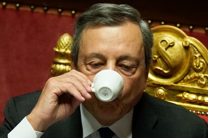Italian Prime Minister Mario Draghi drinks a coffee after he delivered his speech at the Senate in Rome on July 20, 2022.