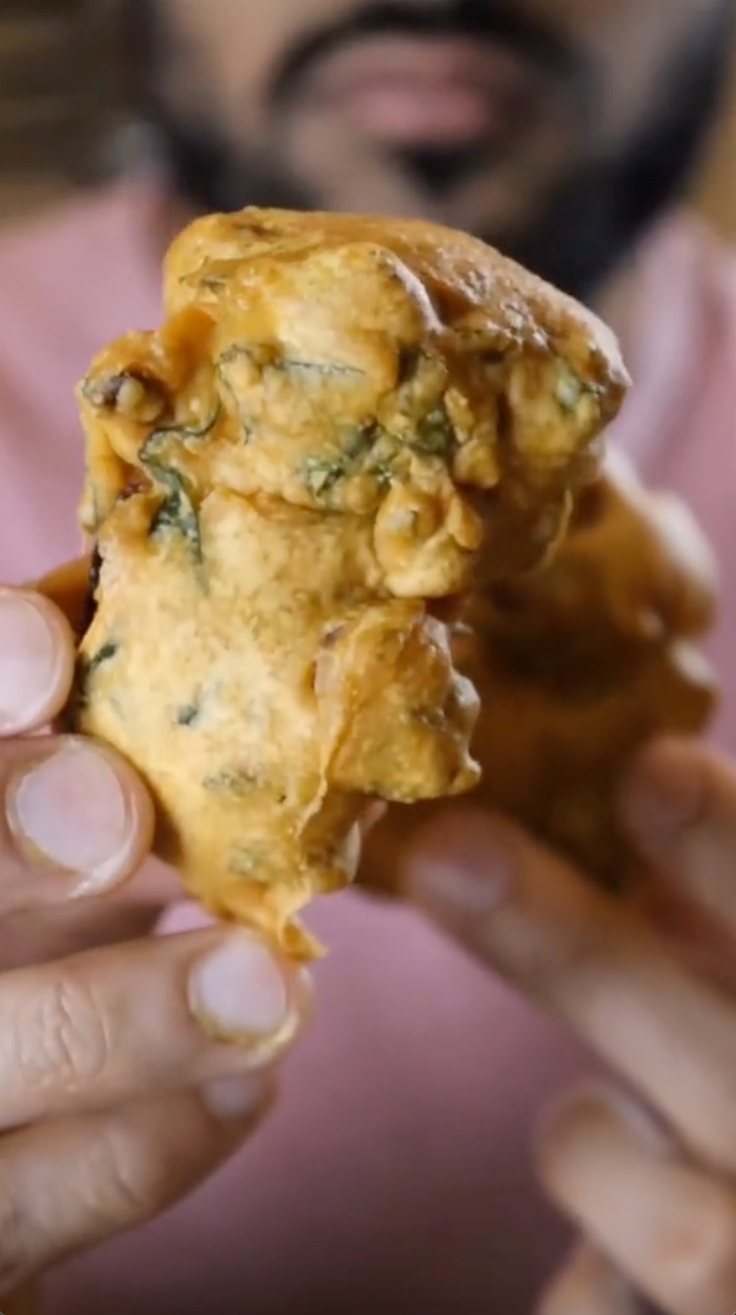 Bilal Bhatti holding a pakora.