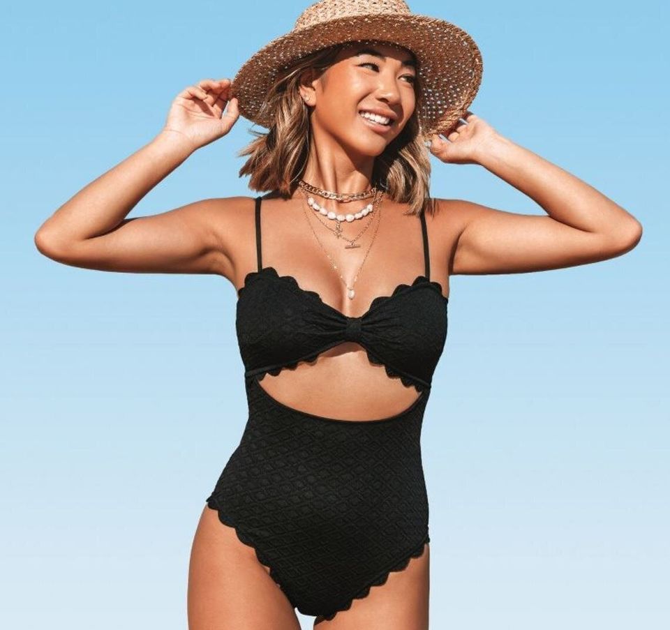 A scalloped, one-piece swimsuit with a cutout midriff design