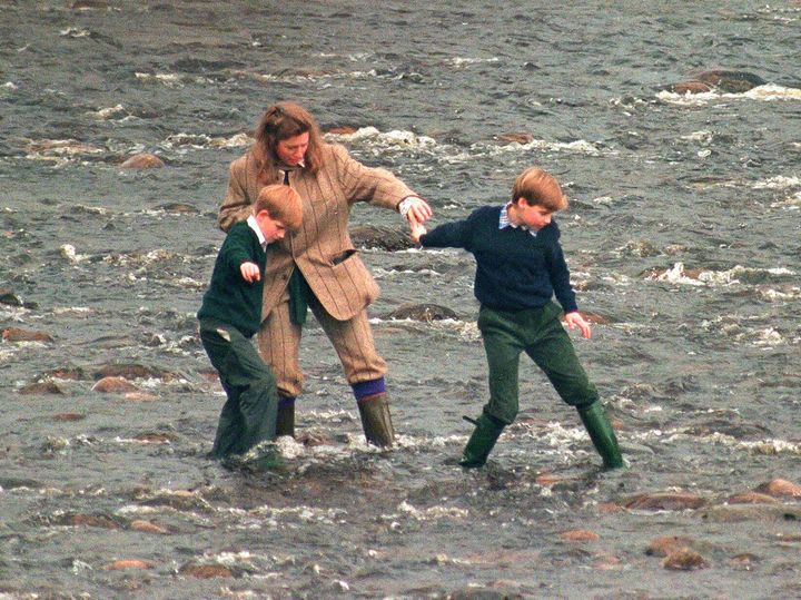 Pettifer leads Prince Harry (left) and Prince William (right) across the River Gairn, near the royal Balmoral Estate, on October 22, 1994.