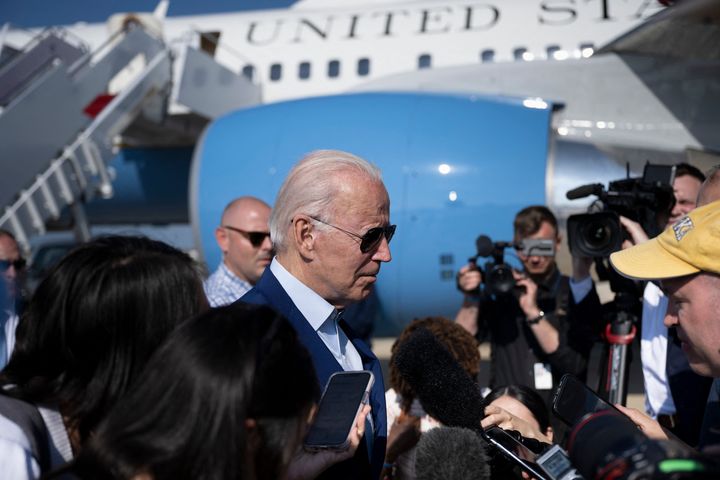 President Joe Biden speaks to members of the media after disembarking Air Force One at Joint Base Andrews in Maryland on Wednesday. The White House announced Thursday that he tested positive for COVID-19.