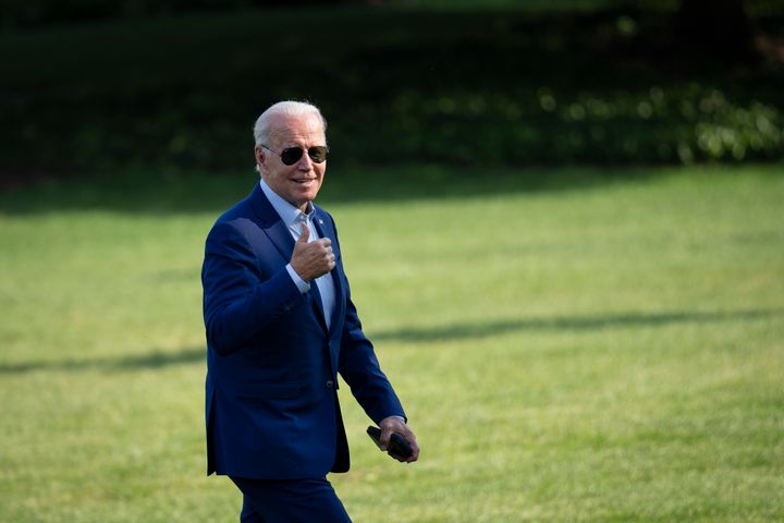 President Biden gestures toward reporters as he walks to the White House on Wednesday after traveling to Somerset, Massachusetts to discuss his next steps on addressing climate change.
