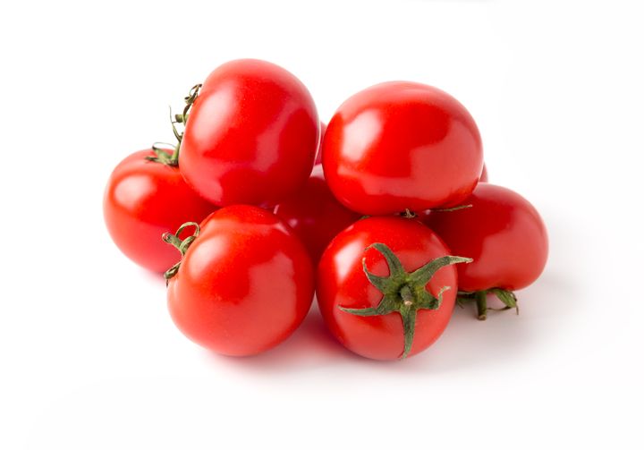 Farm tomatoes, isolated on white background. Group of fresh red tomatoes.