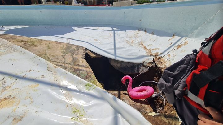 First responders investigate a sinkhole that opened up beneath a pool during an office party in Israel, killing one man and injuring another.