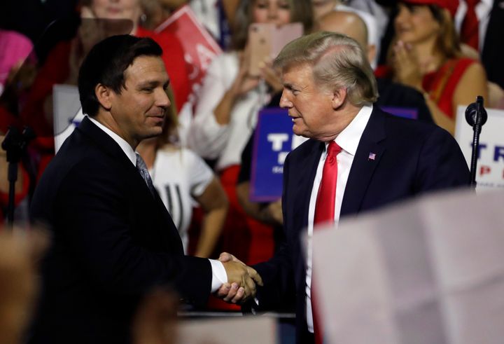 President Donald Trump shakes hands with Ron DeSantis, then a Republican candidate for governor of Florida, at a July 31, 2018, rally in Tampa. 