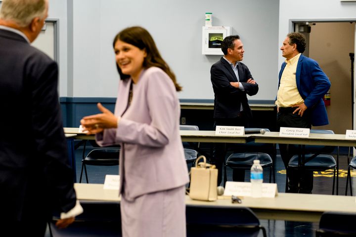 Rep. Haley Stevens (D-Mich.), foreground, talks with Rep. Dan Killdee (D-Mich.) at a UAW panel on Friday. Her opponent, Rep. Andy Levin (D-Mich.), background right, speaks to House Democratic Caucus Vice Chair Pete Aguilar (D-Calif.).