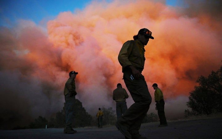 Quick-Shifting Wildfire Close to Yosemite Nationwide Park Explodes In Measurement 3 U.S. Forest firefighters stand along Triangle Road watching a wildfire called the Oak Fire burn east of Midpines in Mariposa County, Calif., Friday, July 22, 2022. The fast-moving wildfire near Yosemite National Park erupted Friday afternoon and prompted evacuations even as firefighters made progress against an earlier blaze that burned to the edge of a grove of giant sequoias. (Eric Paul Zamora/The Fresno Bee via AP)