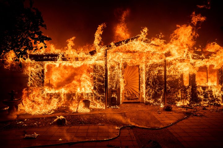 Flames consume a home on Triangle Rd. as the Oak Fire burns in Mariposa County, Calif., on Saturday, July 23, 2022. (AP Photo/Noah Berger)