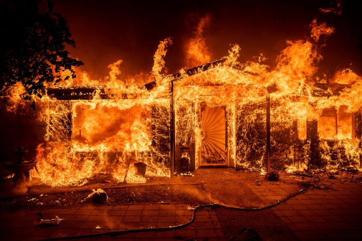 Flames consume a home on Triangle Rd. as the Oak Fire burns in Mariposa County, Calif., on Saturday, July 23, 2022. (AP Photo/Noah Berger)