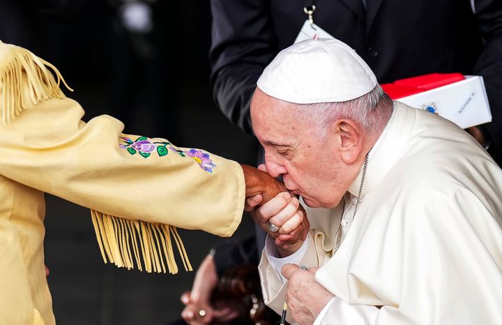 Pope Francis kisses the hand of residential school survivor Elder Alma Desjarlais of the Frog Lake First Nation as he arrives in Edmonton, Alberta, Canada, on Sunday, July 24, 2022. 