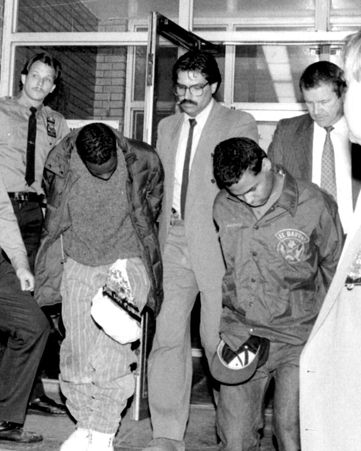 Defendants Clarence Thomas (left) and Steven Lopez (right) are seen being escorted by New York City police detectives following the 1989 rape and assault of a jogger.