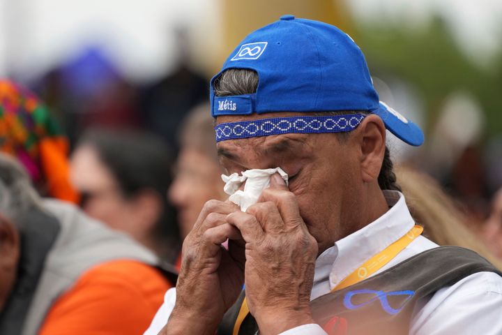 An Indigenous man wipes away tears after Pope Francis delivered his apology to Indigenous people.