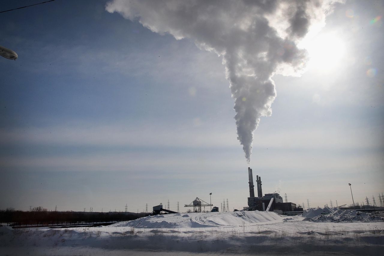 Smoke rises from a coal-fired power plant in February 2019 in Romeoville, Illinois. A recent polar vortex had taxed power systems across the Midwest as demand for electricity climbed as temperatures plunged.