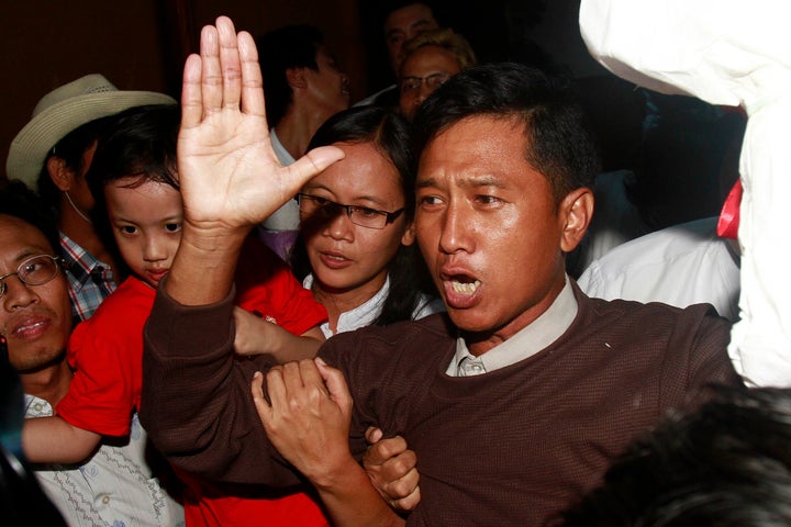 FILE - Kyaw Min Yu, a pro-democracy activist talks to journalists as he arrives at Yangon airport welcomed by his wife Nilar Thein, background, also an activist and his daughter after being released from a prison on Jan. 13, 2012, in Yangon. Myanmar has carried out its first executions in nearly 50 years. Kyaw Min Yu, a 53-year-old democracy activist better known as Ko Jimmy, was executed for violating the counterterrorism law. (AP Photo/File)