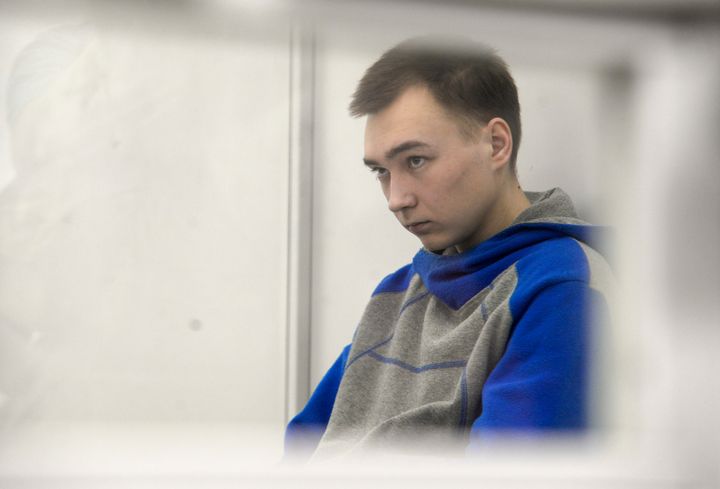 Russian army Sergeant Vadim Shishimarin, 21, is seen behind glass during a court hearing in Kyiv, Ukraine, on July 25, 2022. Kyiv Appeal court has started to consider an appeal on a life sentence for Shishimarin after he was sentenced for the killing of a 62-year-old man who was shot in the head in a village in the northeastern Sumy region in the opening days of the war. 