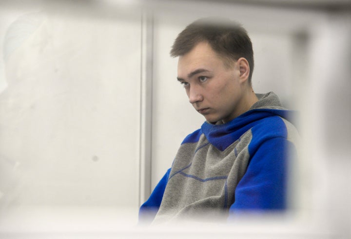 Russian army Sergeant Vadim Shishimarin, 21, is seen behind glass during a court hearing in Kyiv, Ukraine, on July 25, 2022. Kyiv Appeal court has started to consider an appeal on a life sentence for Shishimarin after he was sentenced for the killing of a 62-year-old man who was shot in the head in a village in the northeastern Sumy region in the opening days of the war. 