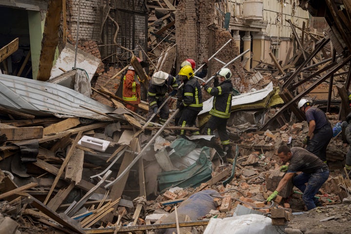 Rescuers remove debris following a Russian missile attack in Chuhuiv, Kharkiv region, Ukraine, on July 25, 2022.