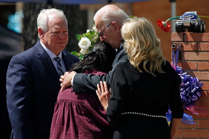 President Joe Biden and first lady Jill Biden comfort Principal Mandy Gutierrez as Superintendent Hal Harrell stands next to them, at a memorial outside Robb Elementary School in May.