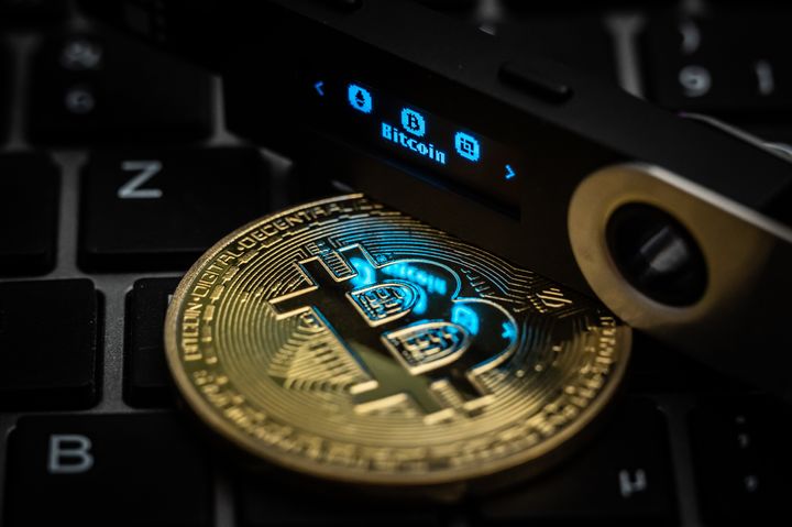 05 July 2022, Baden-Wuerttemberg, Rottweil: The word Bitcoin can be seen on the display of a Ledger Nano S hardware wallet next to a symbolic "Bitcoin coin". Photo: Silas Stein/dpa (Photo by Silas Stein/picture alliance via Getty Images)