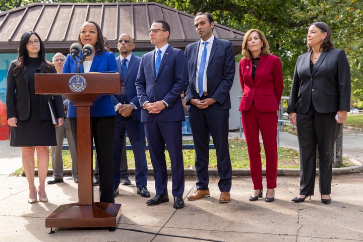 Kristen Clarke, at podium, Assistant Attorney General for the Justice Department's Civil Rights Division, is joined with, from left, New Jersey First Assistant Attorney General Lyndsay Ruotolo, Pennsylvania state Sen. Vincent Hughes, Pennsylvania Attorney General Josh Shapiro, Rohit Chopra, CFPB Director, Delaware Attorney General Kathy Jennings and Jacqueline C. Romero, United States Attorney for the Eastern District of Pennsylvania during a press conference at Malcolm X Park, Wednesday morning. July 27, 2022, West Philadelphia, Pa. Trident Mortgage Co., a division of Warren Buffett's Berkshire's HomeServices of America, discriminated against potential Black and Latino homebuyers in Philadelphia, New Jersey and Delaware, the Department of Justice said Wednesday, in what they are calling the second-largest redlining settlement in history. (Alejandro A. Alvarez/The Philadelphia Inquirer via AP)