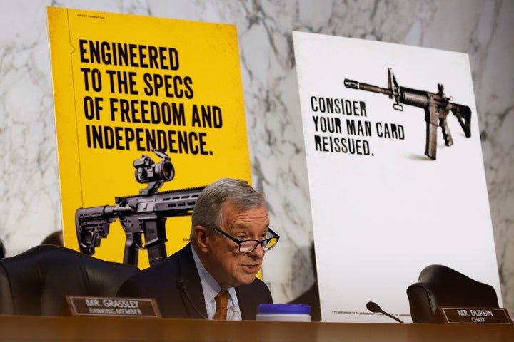 Senate Judiciary Committee Chairman Richard Durbin speaks in front of some of the advertisements the committee gathered for the report.