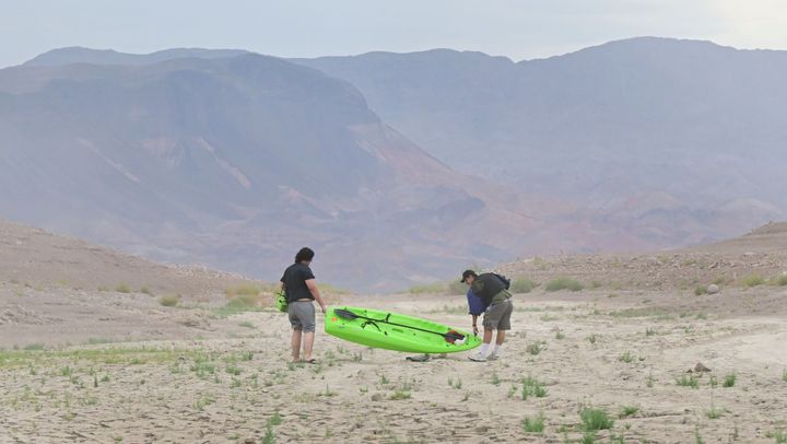 A boat is carried Saturday over land that was once covered in water at Lake Mead in Nevada.