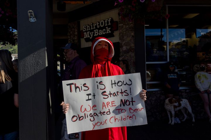 Abortion rights protester Caitlin Devore, dressed as a "handmaiden" takes part in a gathering to protest the Supreme Court's decision in the Dobbs v Jackson Women's Health case on June 24, 2022 in Jackson Hole, Wyoming.