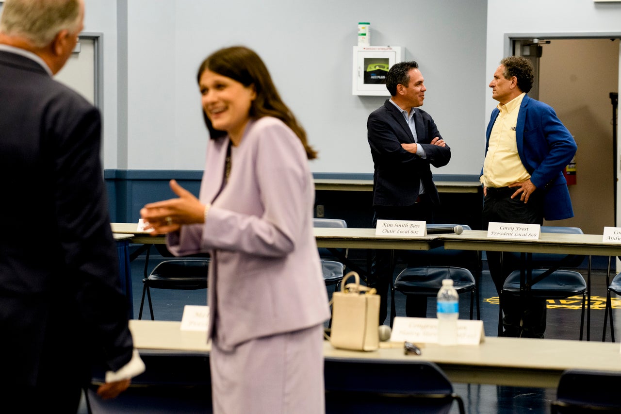 Rep. Andy Levin (D-Mich.), right, chats with Rep. Pete Aguilar (D-Calif.) as Rep. Haley Stevens (D-Mich.), second from left, talks to Rep. Dan Kildee (D-Mich.) before a United Auto Workers panel on microchip legislation.