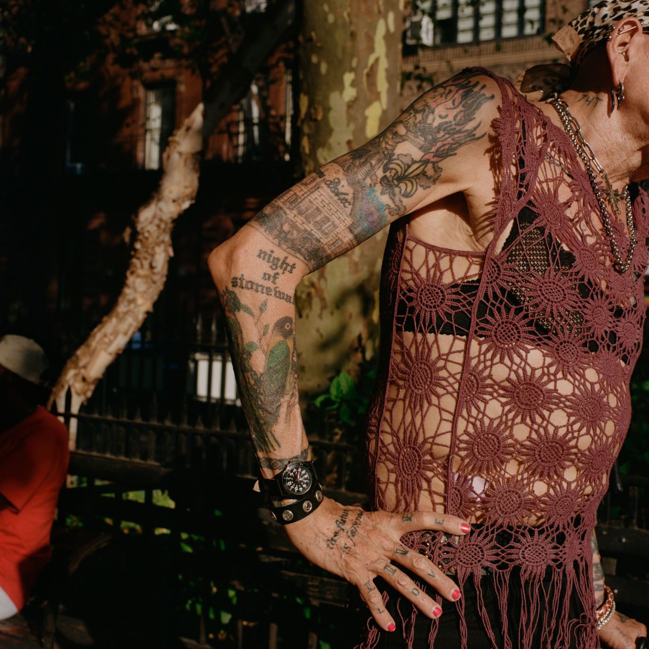 Reneé's body is covered in tattoos, including an image on her right arm of the Stonewall Inn, as it was set up in the 1970s, with silhouettes of rioters in front of large flames.