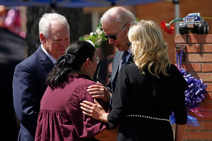 President Joe Biden and first lady Jill Biden comfort principal Mandy Gutierrez as superintendent Hal Harrell stands next to them, at the memorial outside Robb Elementary School to honor the victims killed in this week's school shooting in Uvalde, Texas, on May 29, 2022. 