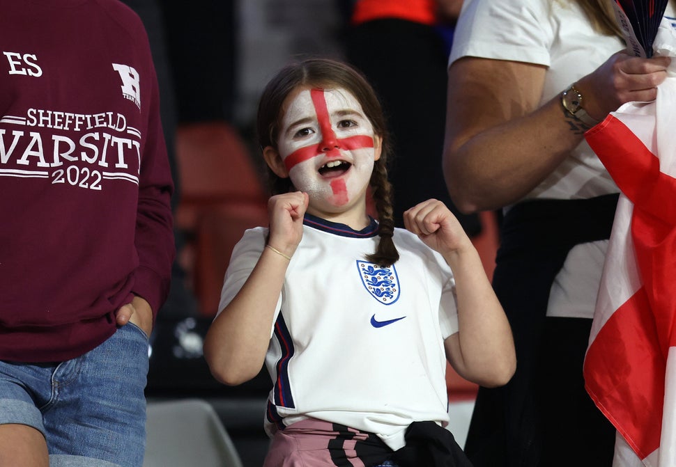 A young England fan cheers on the Lionesses during the England-Sweden game.