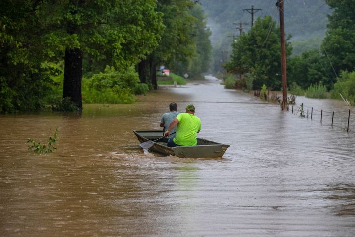 Men ride along flooded Wolverine Road in Breathitt County on July 28.