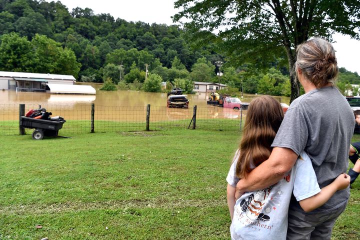 Bonnie Combs, right, hugs her 10-year-old granddaughter Adelynn Bowling as her property becomes covered by the North Fork of the Kentucky River in Jackson on July 28.