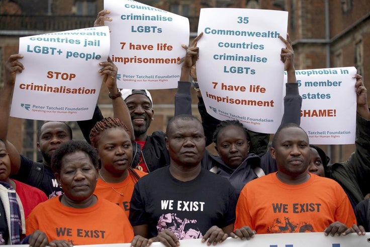 Demonstrators hold up signs and a banner during an LGBTQ+ protest at Aston Hall ahead of the Commonwealth Games in Birmingham, England on July 28.