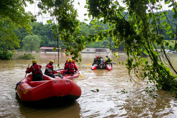 Lexington Firefighters rescue teams head up overflowed Troublesome Creek on July 29 to rescue people who've been stranded since Wednesday night in Lost Creek, Kentucky.