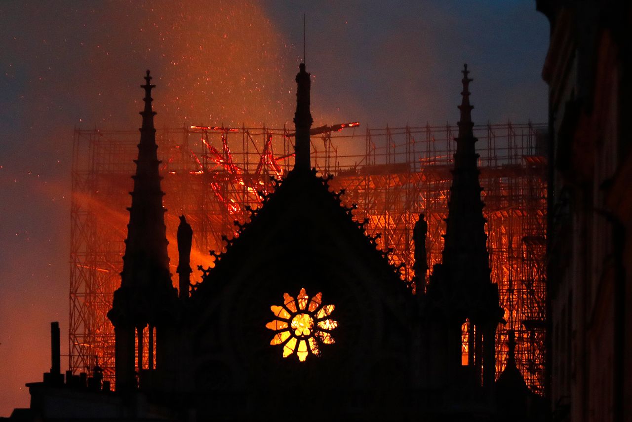 FILE - Flames and smoke rise from Notre Dame Cathedral as it burns on April 15, 2019 in Paris. French President Emmanuel Macron pledged to rebuild Paris' beloved Notre Dame Cathedral "even more beautifully" after a raging fire destroyed its spire and its roof but spared most of the structure, including the church's twin medieval bell towers. French President Emmanuel Macron has formally announced that he will seek a second term in April’s presidential election. (AP Photo/Thibault Camus, File)