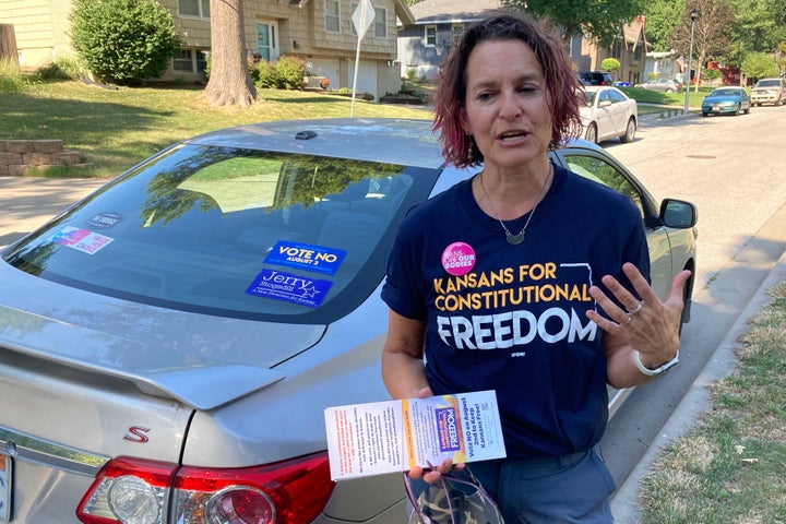 Anne Melia discusses her opposition to a proposed amendment to the Kansas Constitution that would allow legislators to further restrict or ban abortion on July 14, 2022, before she goes door-to-door to talk to prospective voters in Merriam, Kansas. Melia is a Democrat and community activist who is working with the campaign against the proposed amendment.