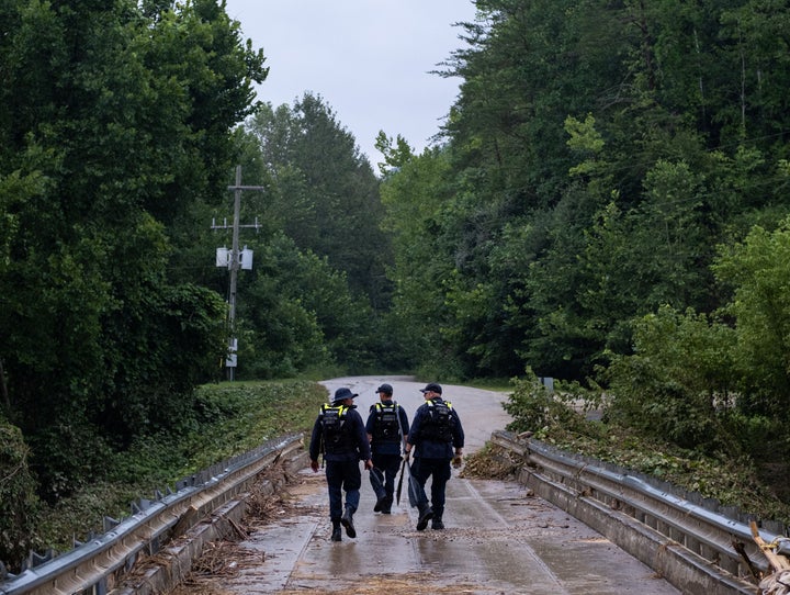 Members of the Lexington Kentucky Fire Department search and rescue team search an area for survivors in Jackson County, Kentucky, on July 31, 2022.