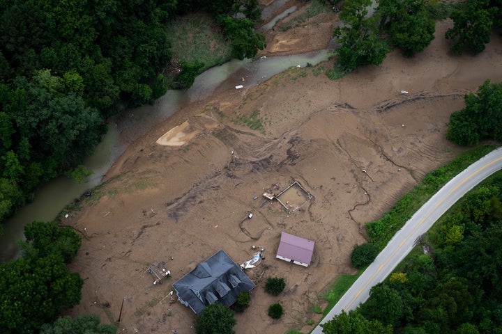 In this aerial view, flood damage is visible as the Kentucky National Guard fly a recon and rescue mission on July 30, 2022 in Breathitt County near Jackson, Kentucky. Flood waters have receded but still surround much of the area. At least 25 people have been killed in the state, with hundreds rescued, but many still unaccounted for amid flooding after heavy rainfall.