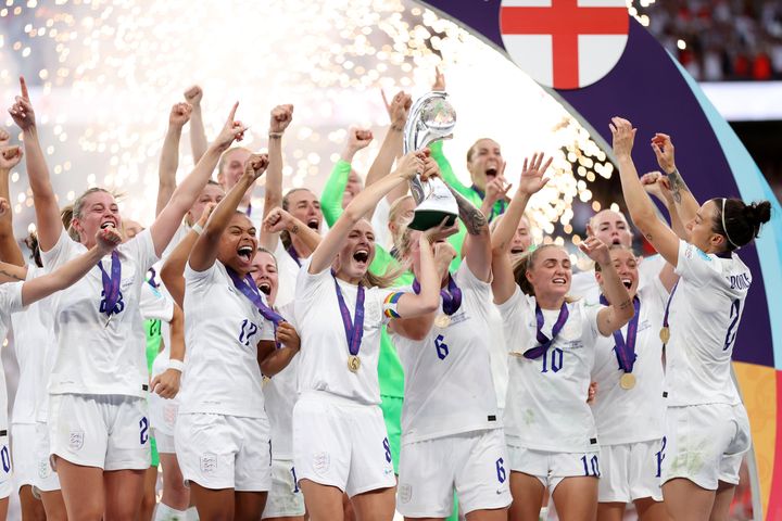 Leah Williamson and Millie Bright of England lift the trophy after their teams victory during the UEFA Women's Euro 2022 final.