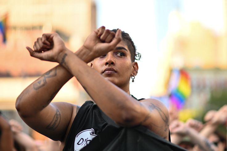 People stop for a moment of silence and raise their arms at the 30th Annual New York City Dyke March on June 25 in New York City. People also protested against the Supreme Court overturning the 50-year-old landmark Roe v. Wade decision ending federal abortion protection.