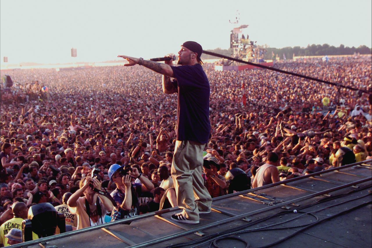Limp Bizkit lead singer Fred Durst performing for an amped-up crowd in a scene from Woodstock shown in the docuseries.