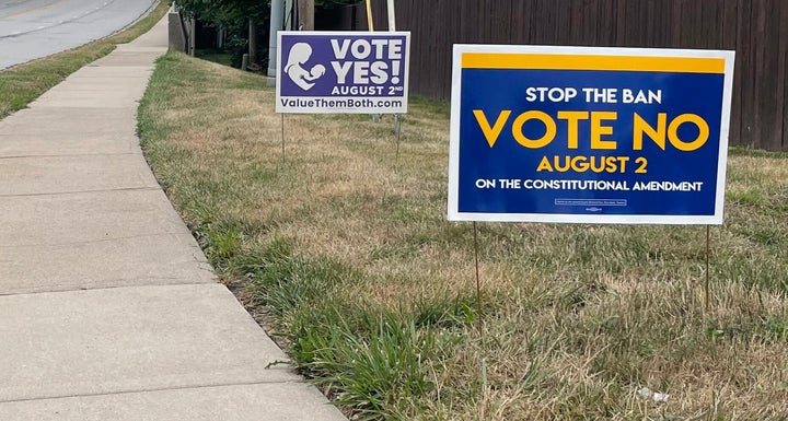 Signs call on voters to vote for or against the Value Them Both amendment in Prairie Village, Kansas, on July 28.